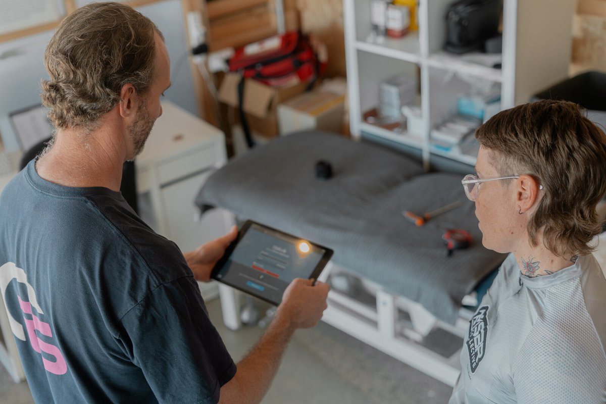 Reviewing slow-motion video footage during a bike fit at On Form Physio